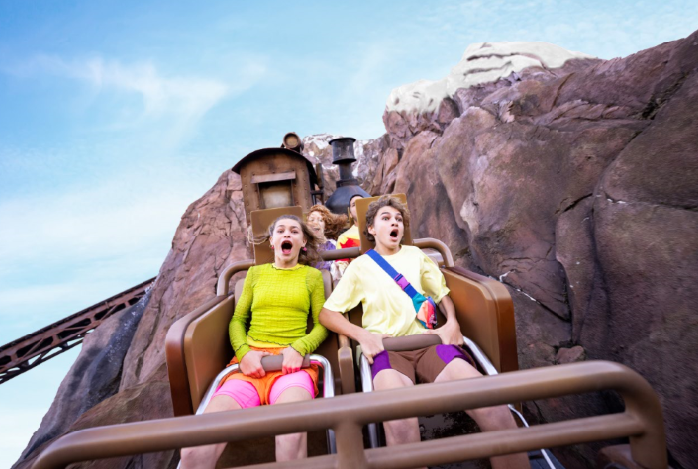 Two tweens scream while riding Expedition Everest at Disney's Animal Kingdom.